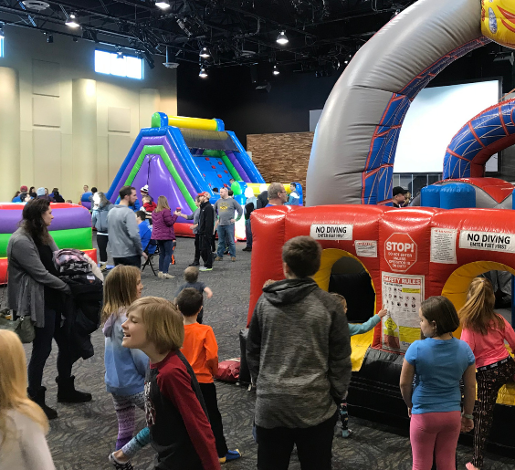 families playing on the inflatables at FamilyFest
