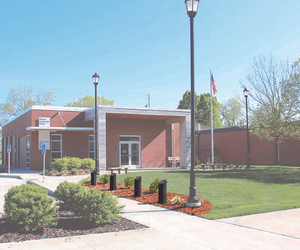 Four black pillars of the Veterans Memorial outside the Waukee Community Center
