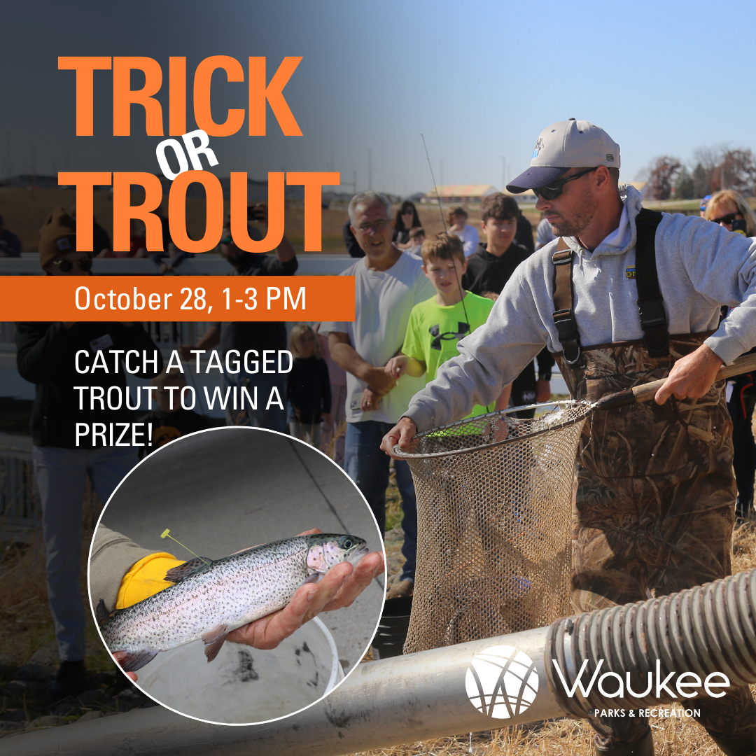 Man carrying a net of fish with crowd in the background