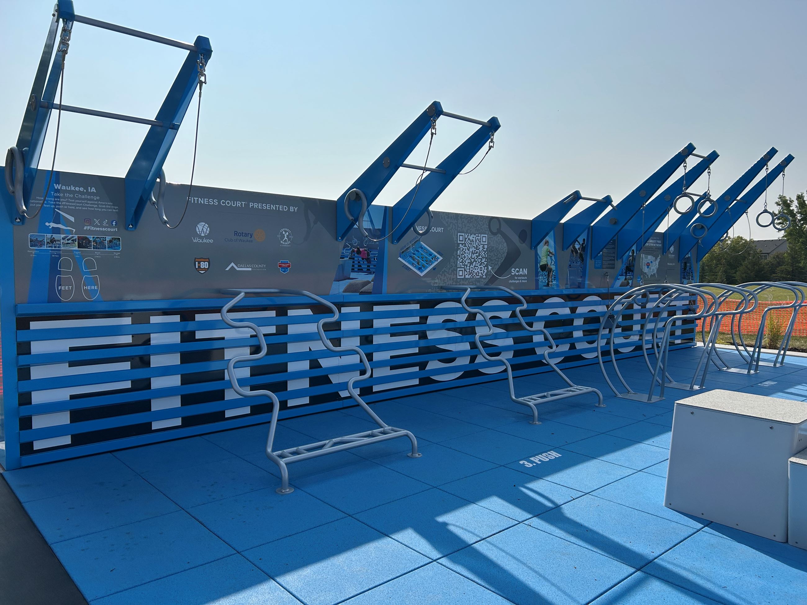 Fitness Court back wall with bars for pull ups, hanging rings and other equipment