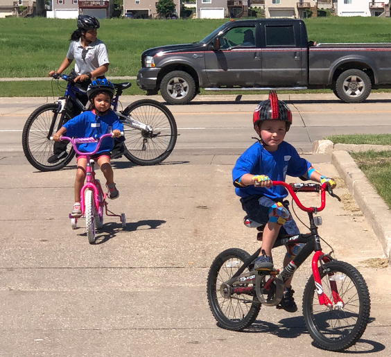 Kids on bikes with a police officer