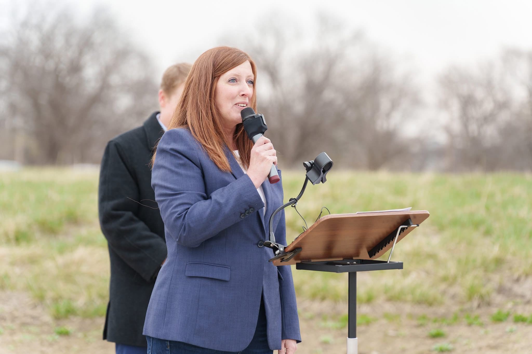 Mayor Clarke with microphone in hand addresses the crowd at groundbreaking for affordable housing